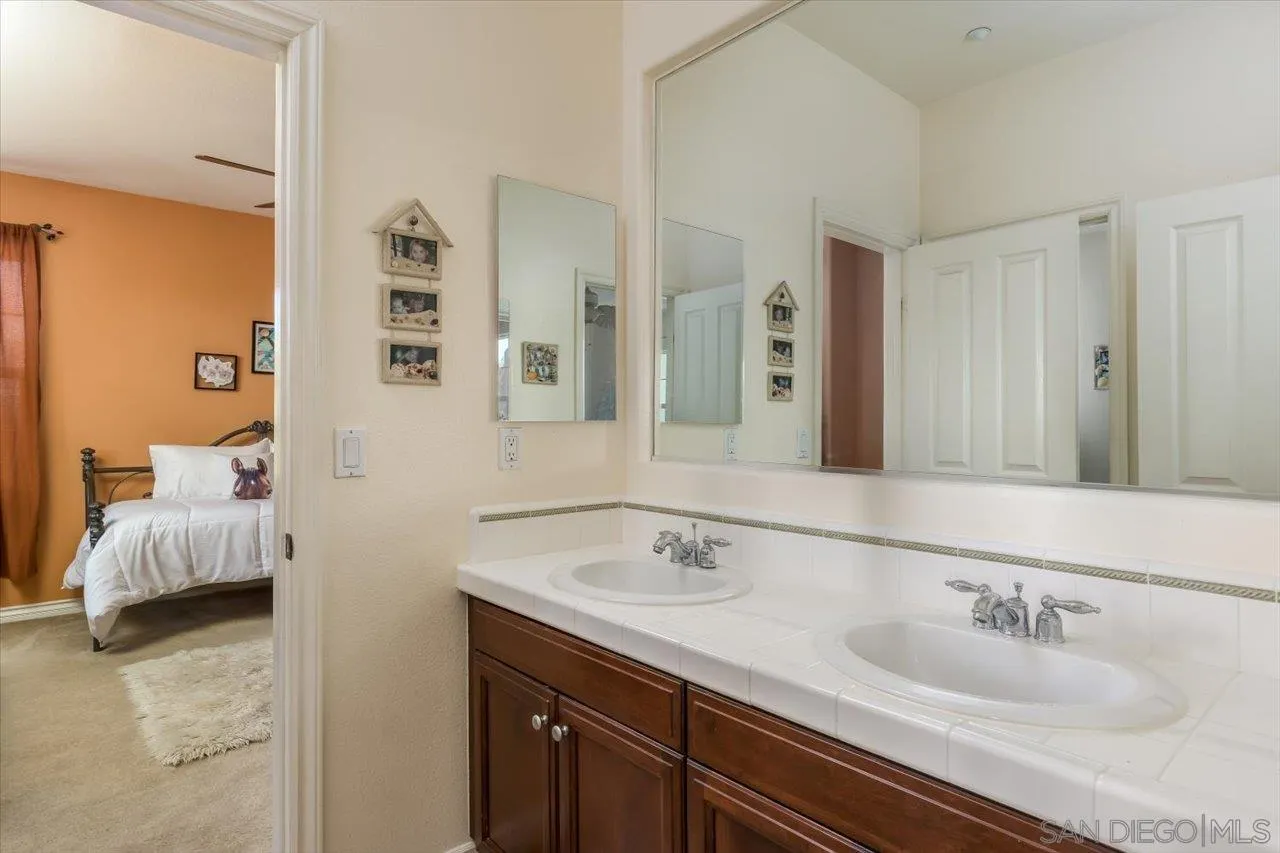 1505 Chateau Lafite Bonsall, CA 92003 - Photo 27 of 47 a en suite bathroom with double sink and a mirror