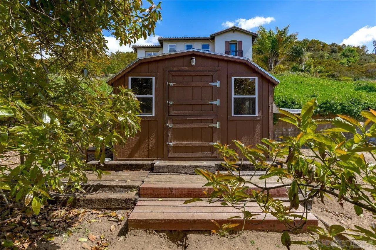 1505 Chateau Lafite Bonsall, CA 92003 - Photo 31 of 47 a front view of a house with a yard
