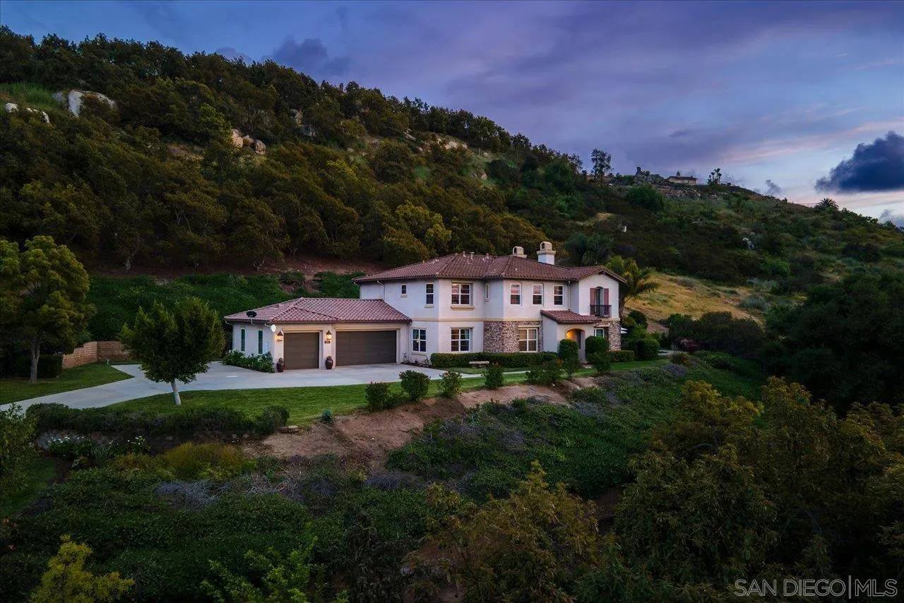 1505 Chateau Lafite Bonsall, CA 92003 - Photo 46 of 47 a front view of a house with a yard and mountain view in back