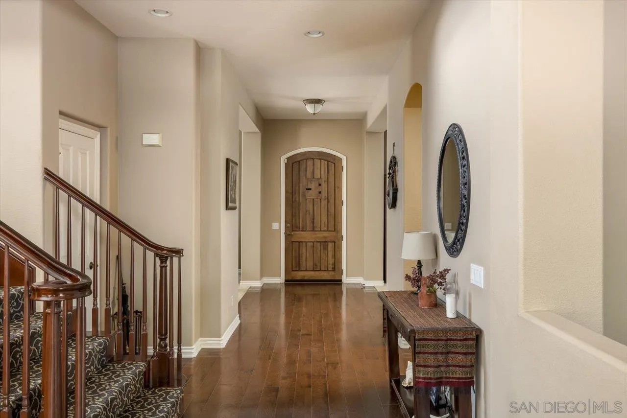 1505 Chateau Lafite Bonsall, CA 92003 - Photo 7 of 47 a view of a hallway with wooden floor and windows