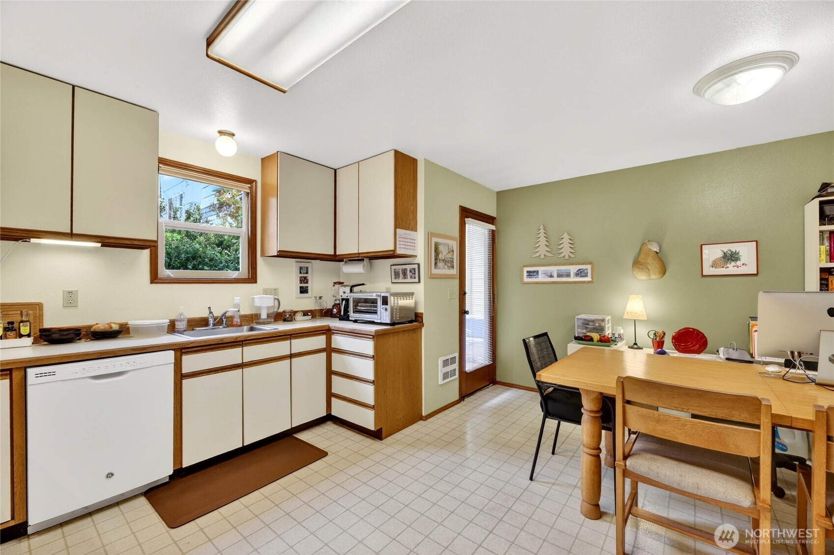 2434 55th Avenue Southwest Seattle, WA 98116 - Photo 17 of 40 a kitchen with a sink cabinets and window