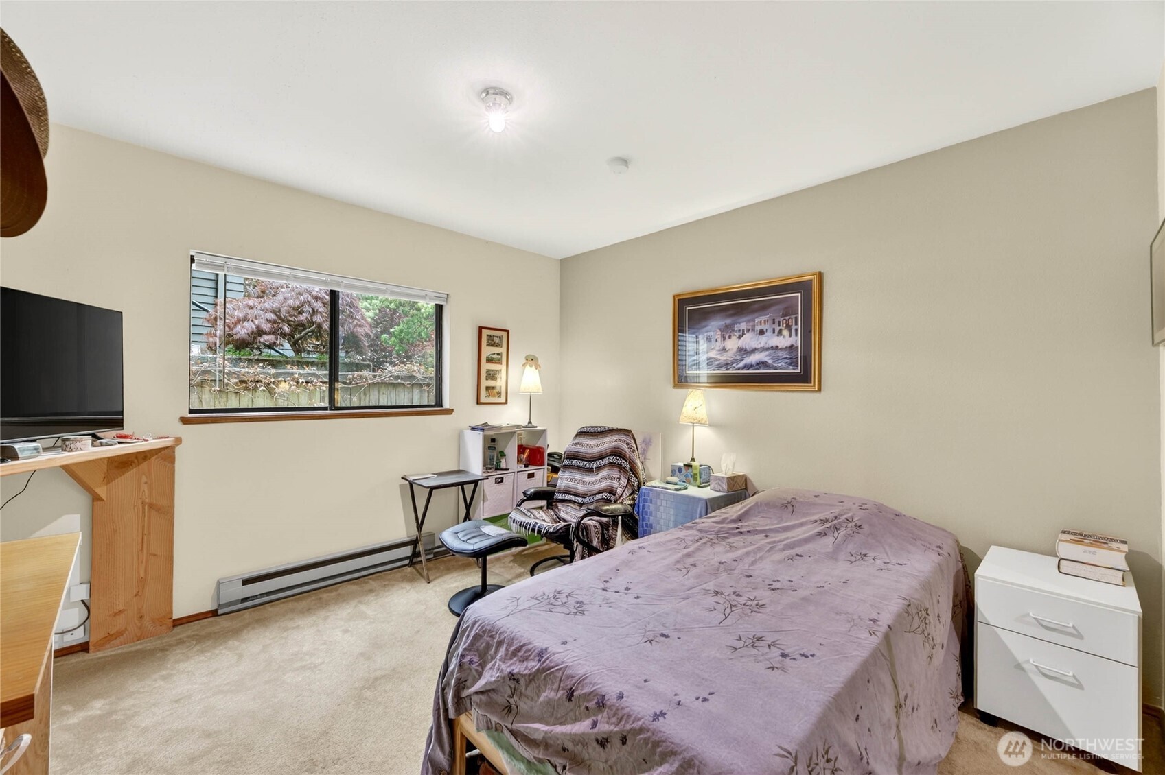 2434 55th Avenue Southwest Seattle, WA 98116 - Photo 21 of 40 a bed room with a bed a television and a window