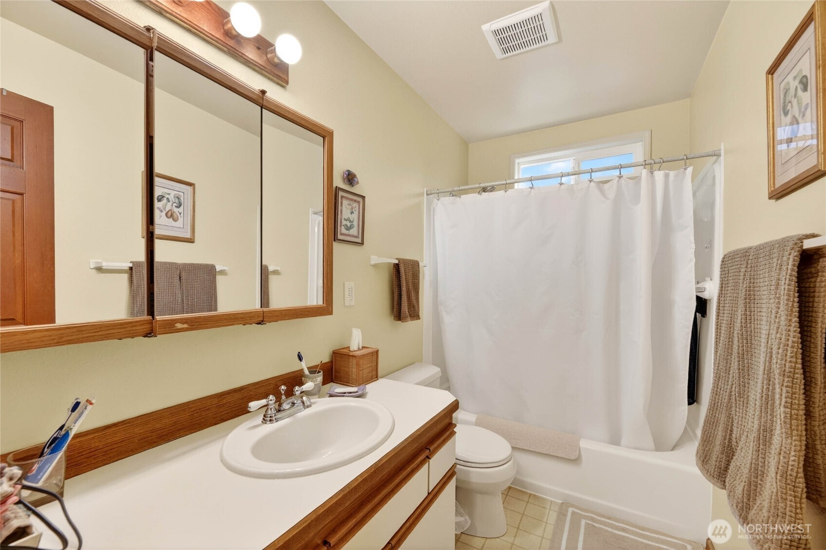2434 55th Avenue Southwest Seattle, WA 98116 - Photo 22 of 40 a bathroom with a sink a toilet and a mirror