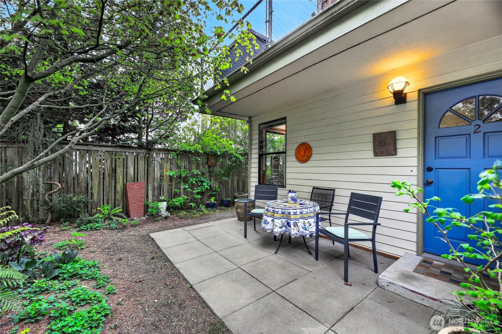 2434 55th Avenue Southwest Seattle, WA 98116 - Photo 25 of 40 a view of a chairs and table in the back yard of the house