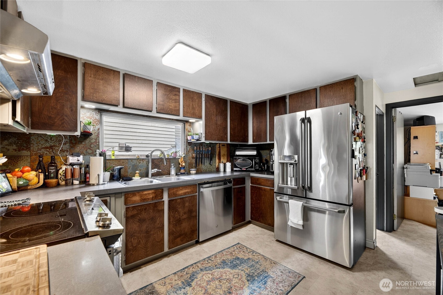 2434 55th Avenue Southwest Seattle, WA 98116 - Photo 29 of 40 a kitchen with stainless steel appliances granite countertop a refrigerator stove and sink