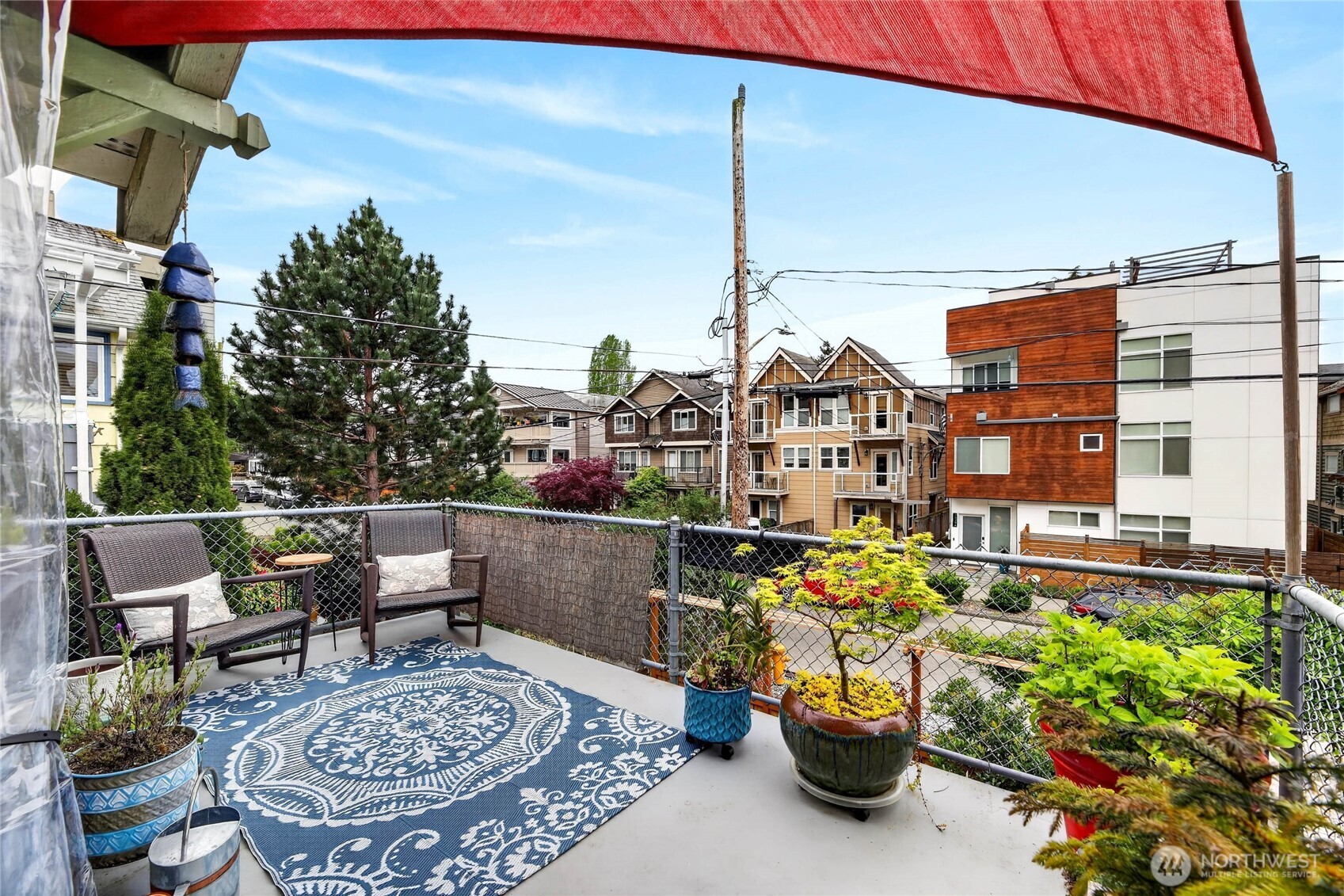 2434 55th Avenue Southwest Seattle, WA 98116 - Photo 36 of 40 a view of a patio with a table and chairs and potted plants