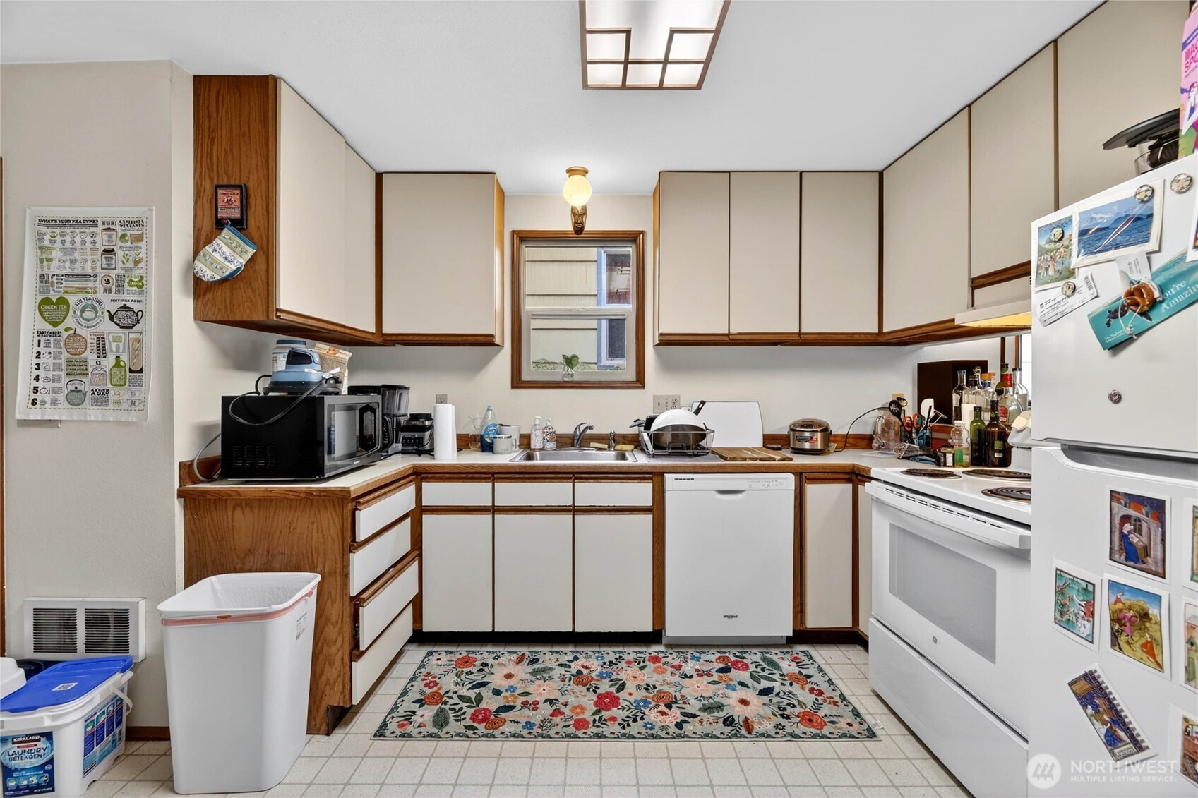 2434 55th Avenue Southwest Seattle, WA 98116 - Photo 7 of 40 a kitchen with stainless steel appliances a stove a sink and a refrigerator