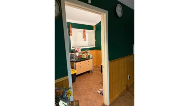 a view of a living room with a chair and a potted plant