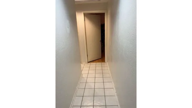 a bed sitting in a bedroom next to a white wall