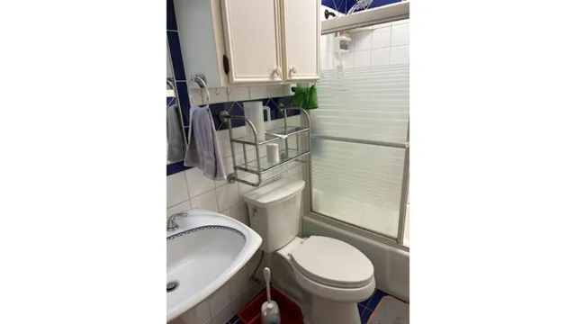 a bedroom with a bed and a white cabinet