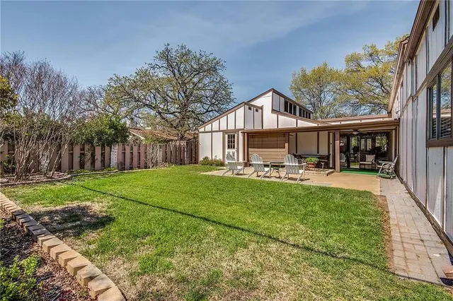 a front view of a house with garden and patio