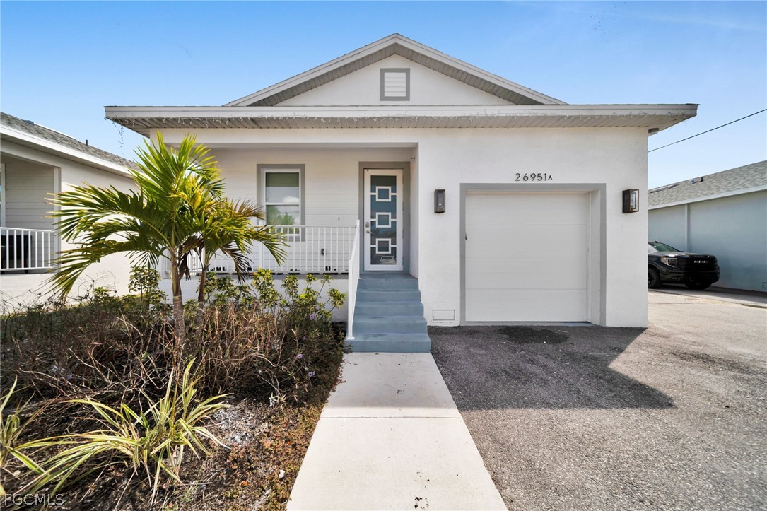26951 North Riverside Drive Bonita Springs, FL 34135 - Photo 1 of 50 a front view of a house with a yard