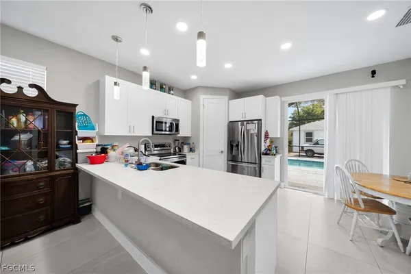 a kitchen with counter top space cabinets and stainless steel appliances