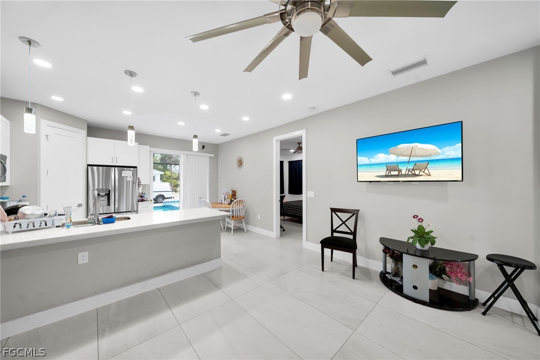 26951 North Riverside Drive Bonita Springs, FL 34135 - Photo 12 of 50 a large white kitchen with lots of counter space and dining table