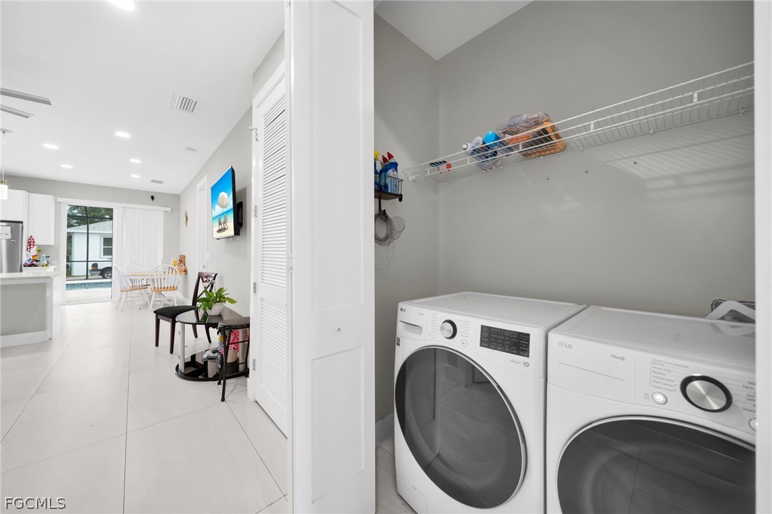26951 North Riverside Drive Bonita Springs, FL 34135 - Photo 13 of 50 a view of storage and utility room with washer and dryer