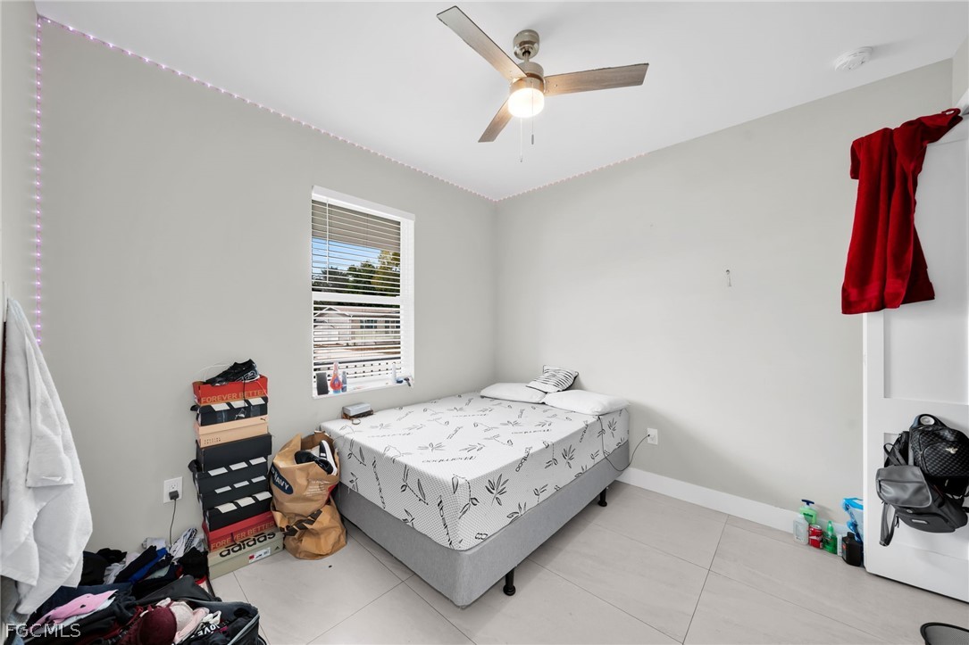 26951 North Riverside Drive Bonita Springs, FL 34135 - Photo 14 of 50 a bedroom with a bed and a window