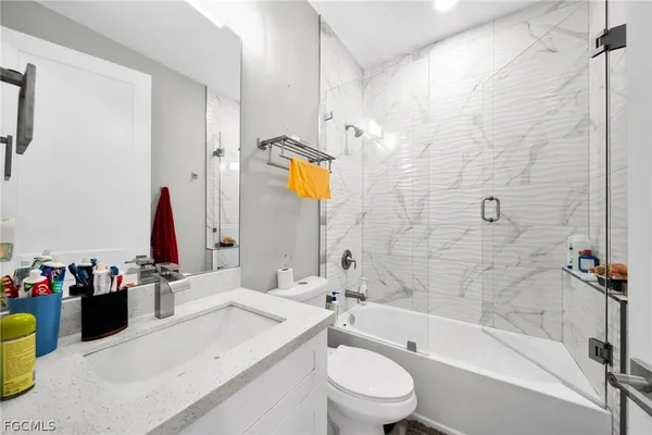 a bathroom with a sink mirror toilet and bathtub