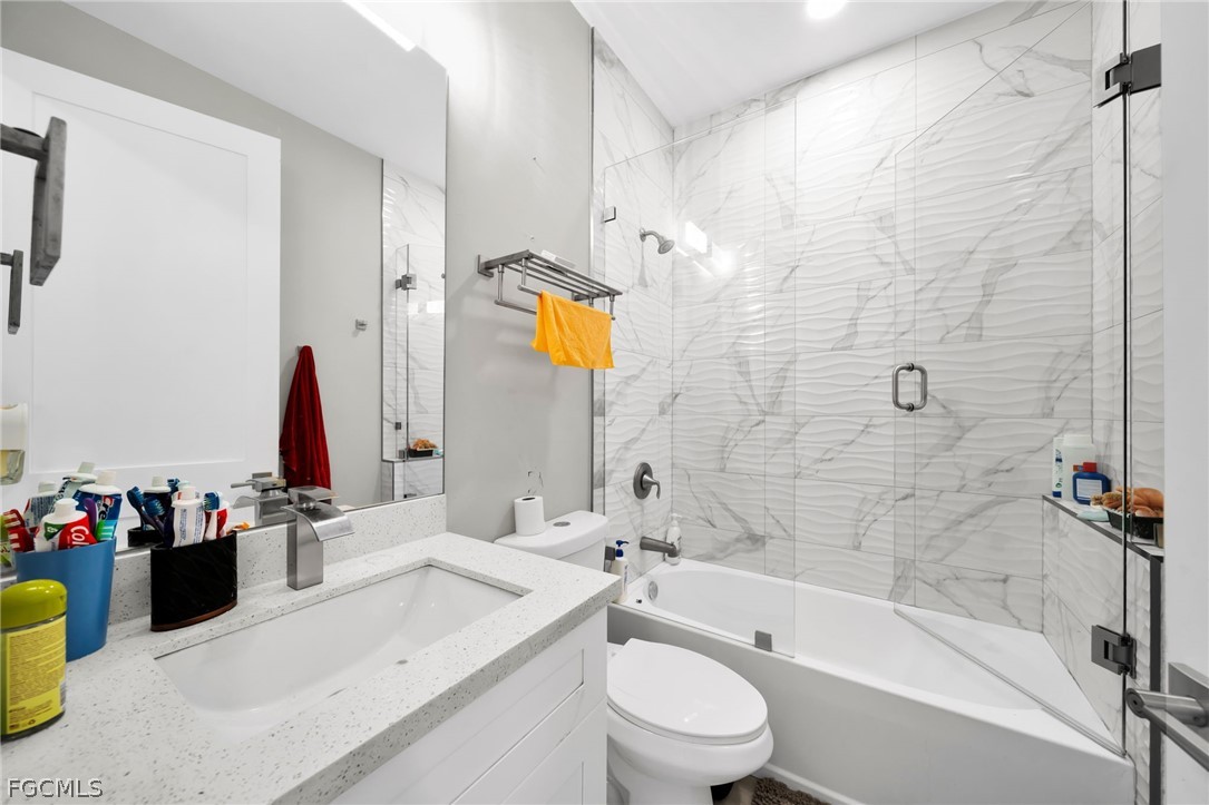 26951 North Riverside Drive Bonita Springs, FL 34135 - Photo 15 of 50 a bathroom with a sink mirror toilet and bathtub