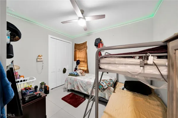 a bedroom with a bed and a tv