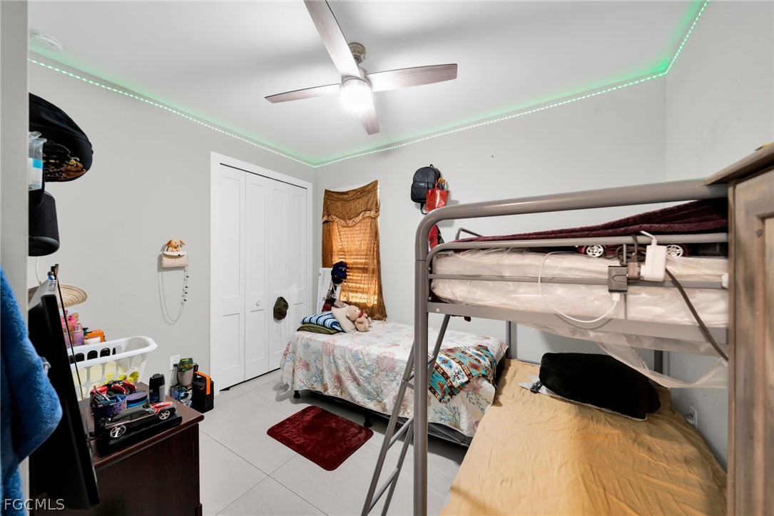 26951 North Riverside Drive Bonita Springs, FL 34135 - Photo 17 of 50 a bedroom with a bed and a tv
