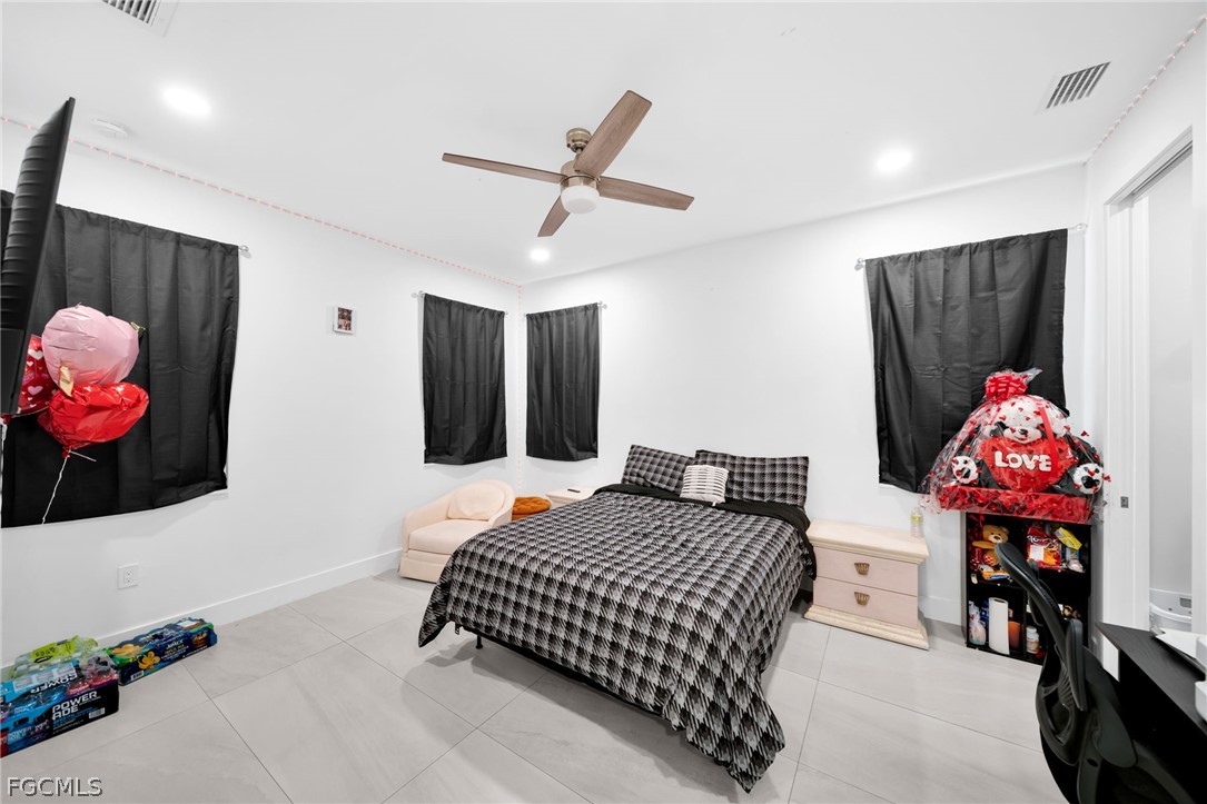 26951 North Riverside Drive Bonita Springs, FL 34135 - Photo 18 of 50 a bedroom with a bed and wooden floor