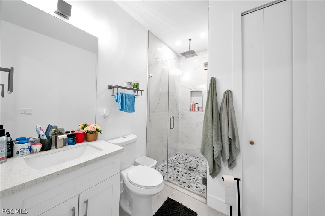 26951 North Riverside Drive Bonita Springs, FL 34135 - Photo 20 of 50 a bathroom with a sink toilet and shower