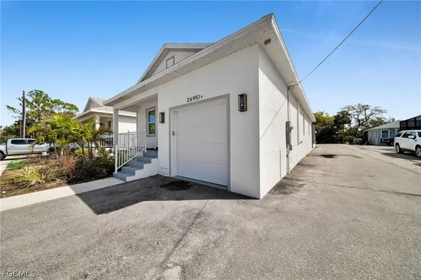a view of a white house with a yard