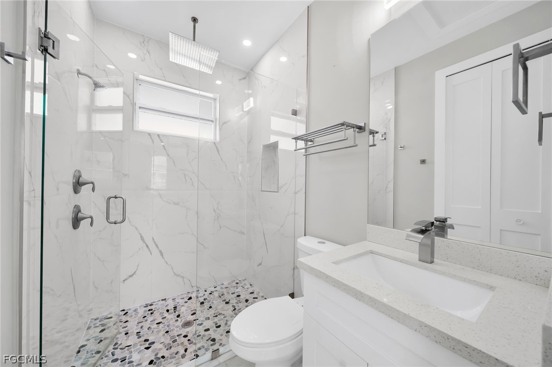 26951 North Riverside Drive Bonita Springs, FL 34135 - Photo 22 of 50 a bathroom with a sink a toilet and shower