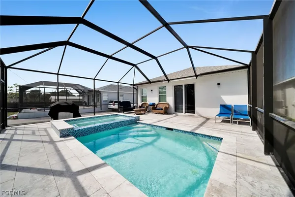 a view of a backyard with sitting area