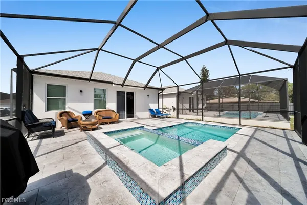 a view of swimming pool with seating area and furniture