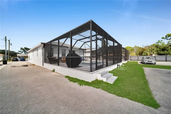 a view of a house with a yard and pathway