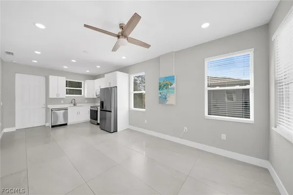 a kitchen with white cabinets and stainless steel appliances