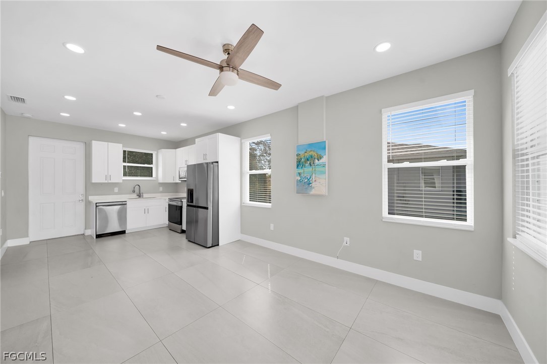 26951 North Riverside Drive Bonita Springs, FL 34135 - Photo 31 of 50 a kitchen with white cabinets and stainless steel appliances