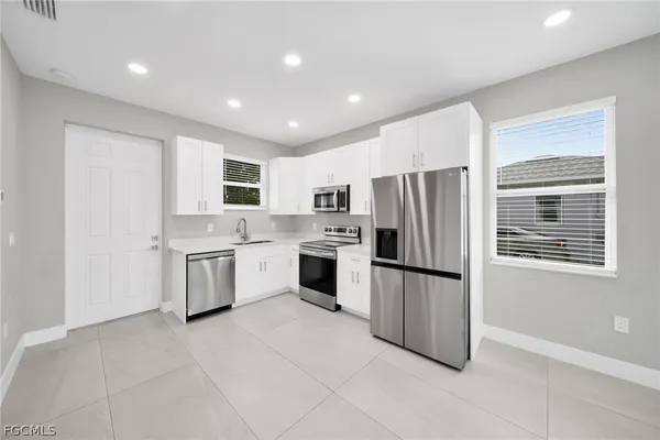 a kitchen with a refrigerator sink and microwave