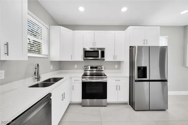 a kitchen with cabinets stainless steel appliances and a counter space
