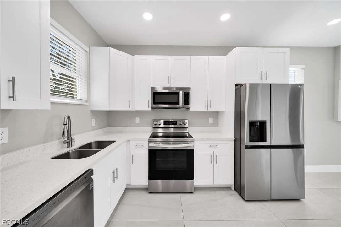 26951 North Riverside Drive Bonita Springs, FL 34135 - Photo 35 of 50 a kitchen with cabinets stainless steel appliances and a counter space