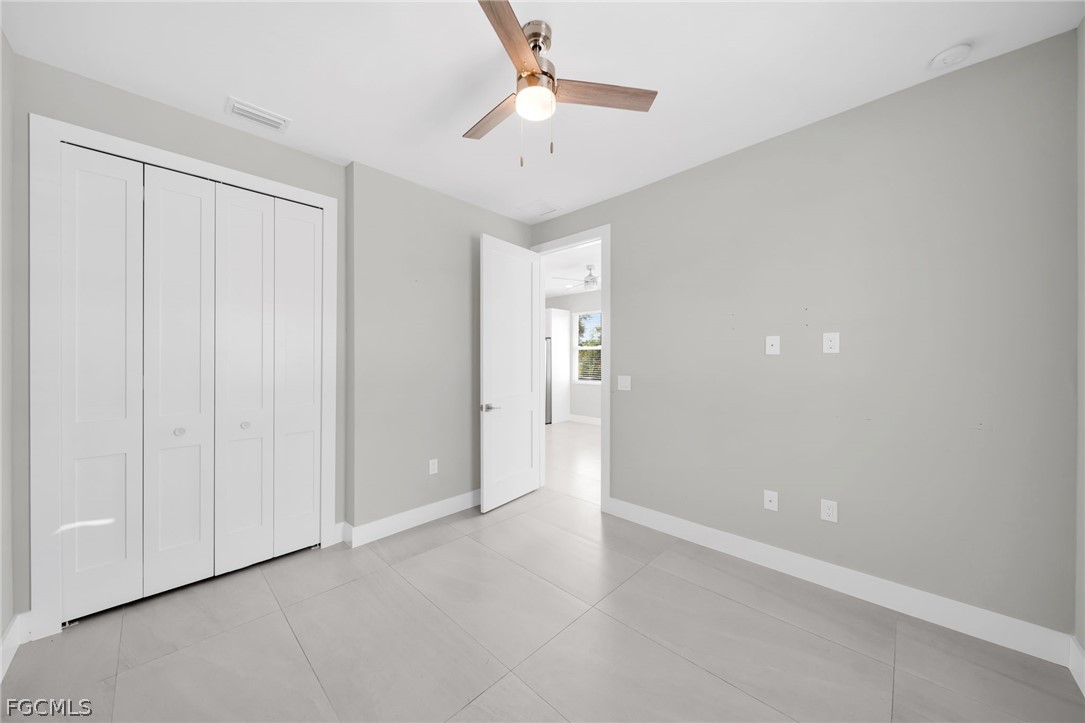 26951 North Riverside Drive Bonita Springs, FL 34135 - Photo 38 of 50 wooden floor in an empty room with a chandelier fan