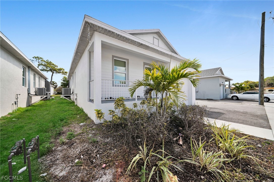 26951 North Riverside Drive Bonita Springs, FL 34135 - Photo 4 of 50 a front view of a house with garden