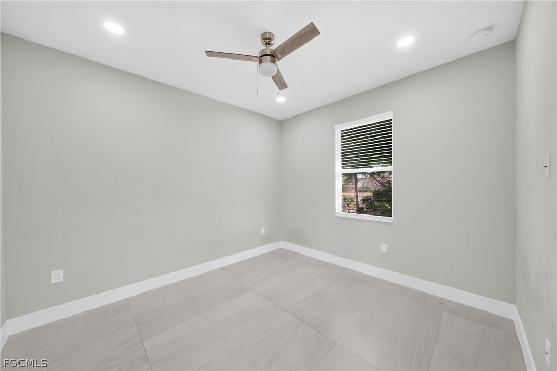 26951 North Riverside Drive Bonita Springs, FL 34135 - Photo 42 of 50 an empty room with a window and ceiling fan