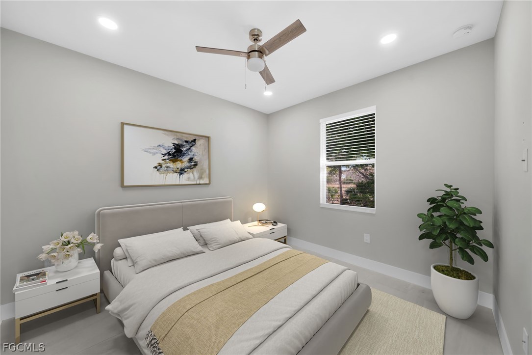 26951 North Riverside Drive Bonita Springs, FL 34135 - Photo 43 of 50 a bedroom with a large bed and a potted plant