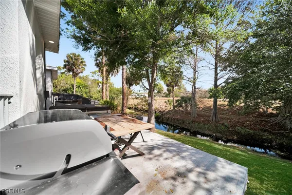a view of backyard with swimming pool and sitting area