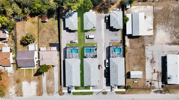 a aerial view of multi story residential apartment building with a yard