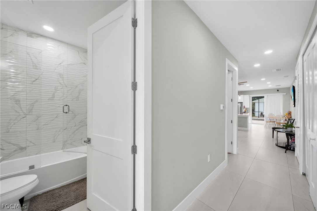 26951 North Riverside Drive Bonita Springs, FL 34135 - Photo 8 of 50 a bathroom with a bathtub shower and toilet