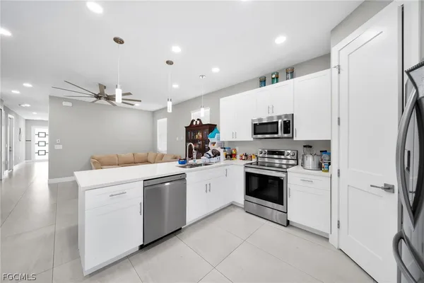 a kitchen with a sink stainless steel appliances and cabinets