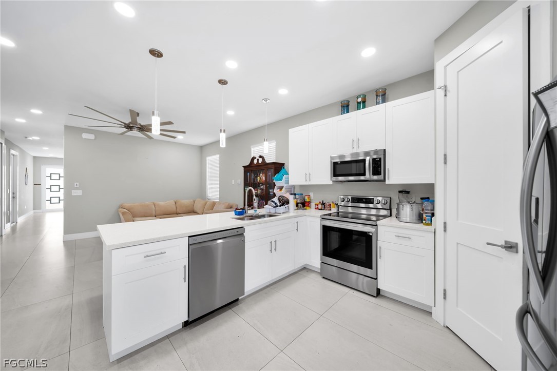 26951 North Riverside Drive Bonita Springs, FL 34135 - Photo 10 of 50 a kitchen with a sink stainless steel appliances and cabinets