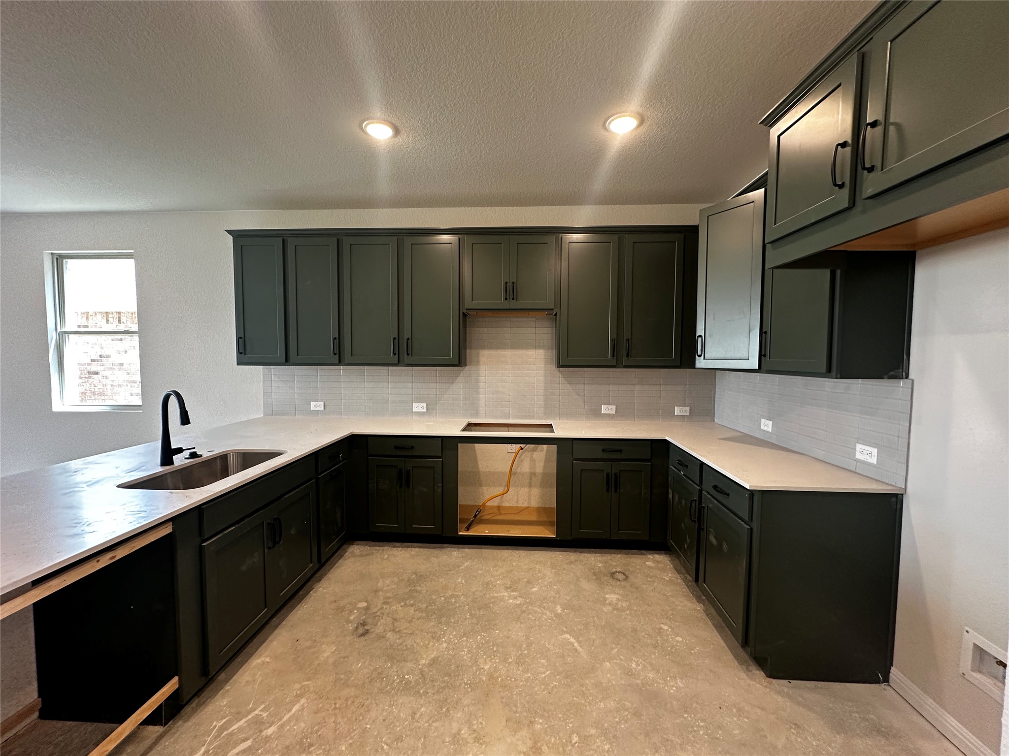 1053 Sienna Bear Road Georgetown, TX 78633 - Photo 6 of 32 a kitchen with a sink and cabinets