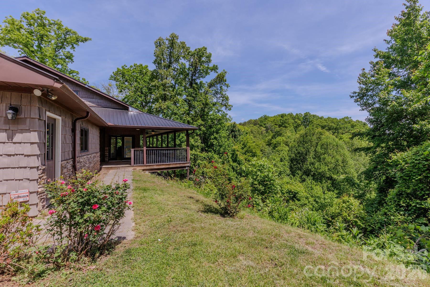 860 Butternut Ridge, Unit 8 Bryson City, NC 28713 - Photo 3 of 47 a view of a house with potted plants and a fountain