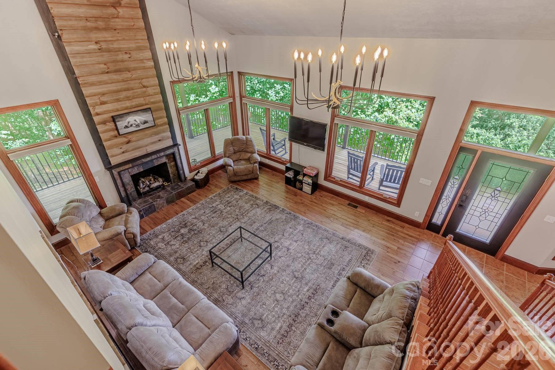 860 Butternut Ridge, Unit 8 Bryson City, NC 28713 - Photo 7 of 47 a view of a livingroom with furniture a flat screen tv and floor to ceiling window