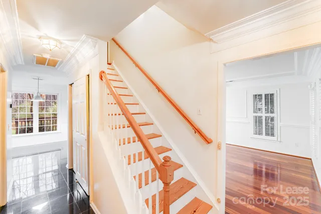 a view of staircase with white walls and a window