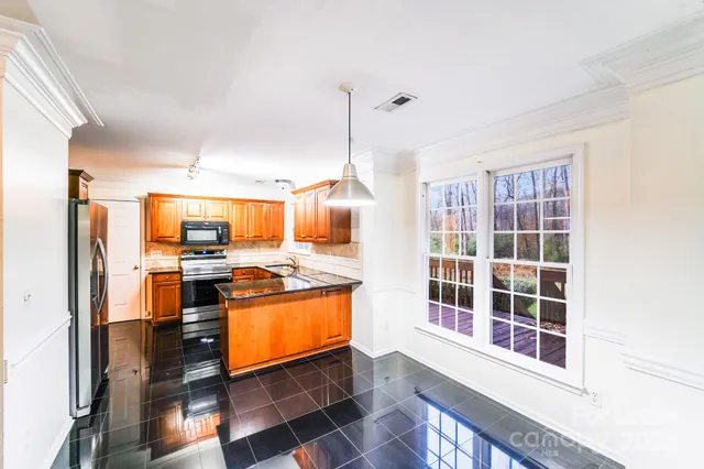 a kitchen with stainless steel appliances granite countertop a stove and a refrigerator